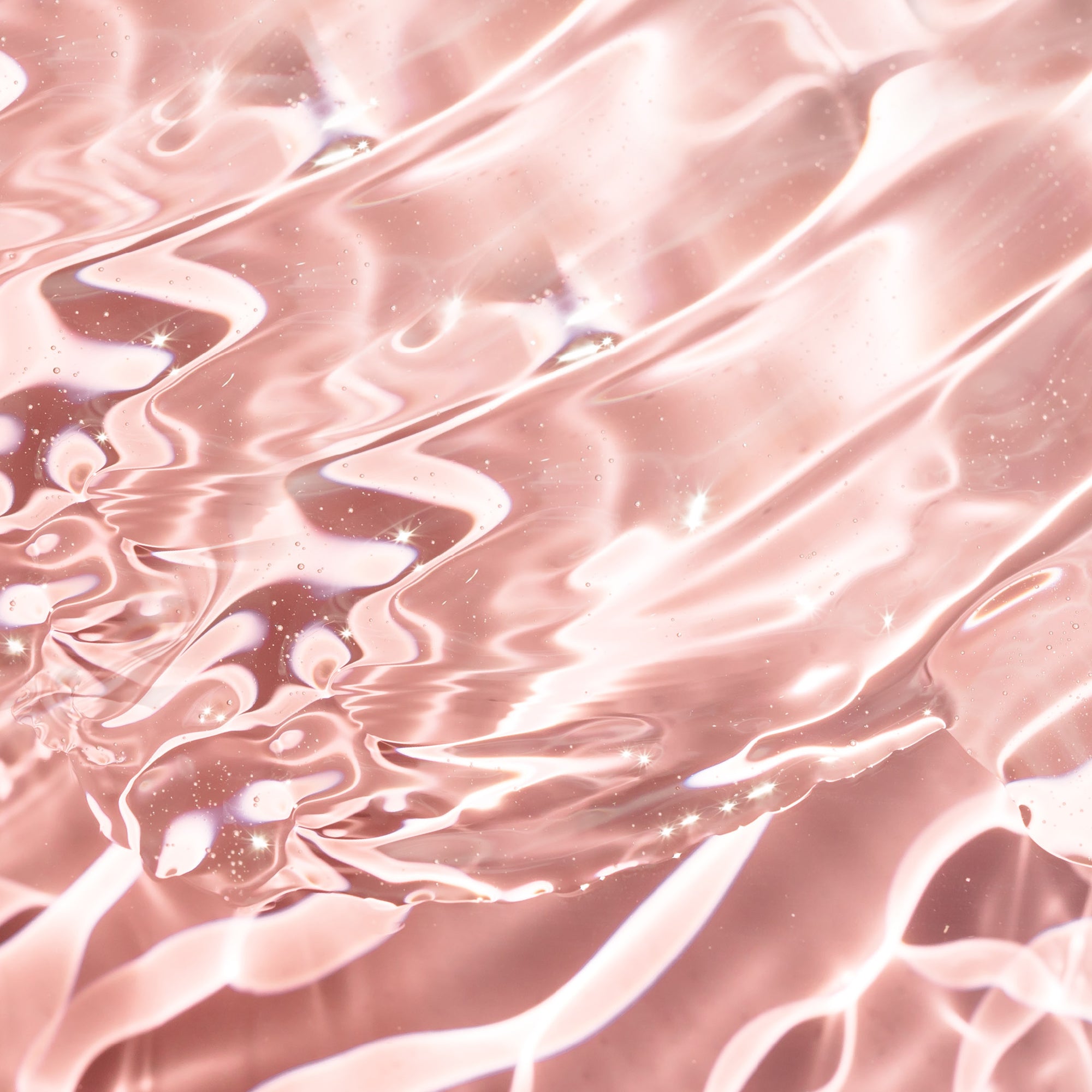 Hyaluronic acid. Crystalline clear liquid with undulating waves, on light pink background. 
