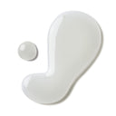 closeup of two droplets of translucent skincare serum on white background