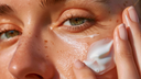 Close-up of a person applying cream to their face